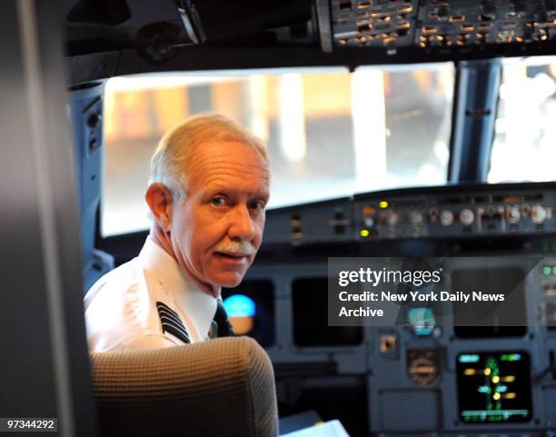 Pilot Chesley 'Sully' Sullenberger looks right at home in the cockpit aboard US Airways flight 1050 to New York, it is his first flight since landing...