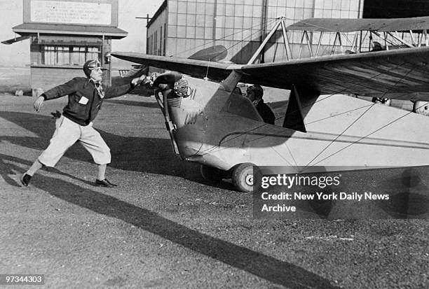 Pilots Eddie Wingerter and Joe Jones, in 25-foot monoplane with two-cylinder engine, before 4,000 miles flight to South America.