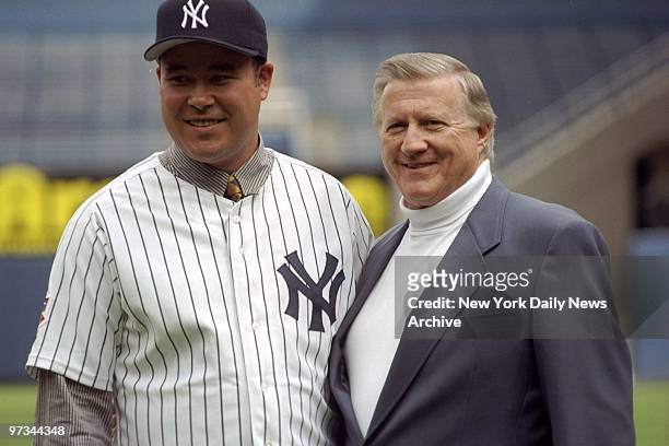 Pitcher Hideki Irabu joins New York Yankees' owner George Steinbrenner after Irabu signed a four-year contract with the team.