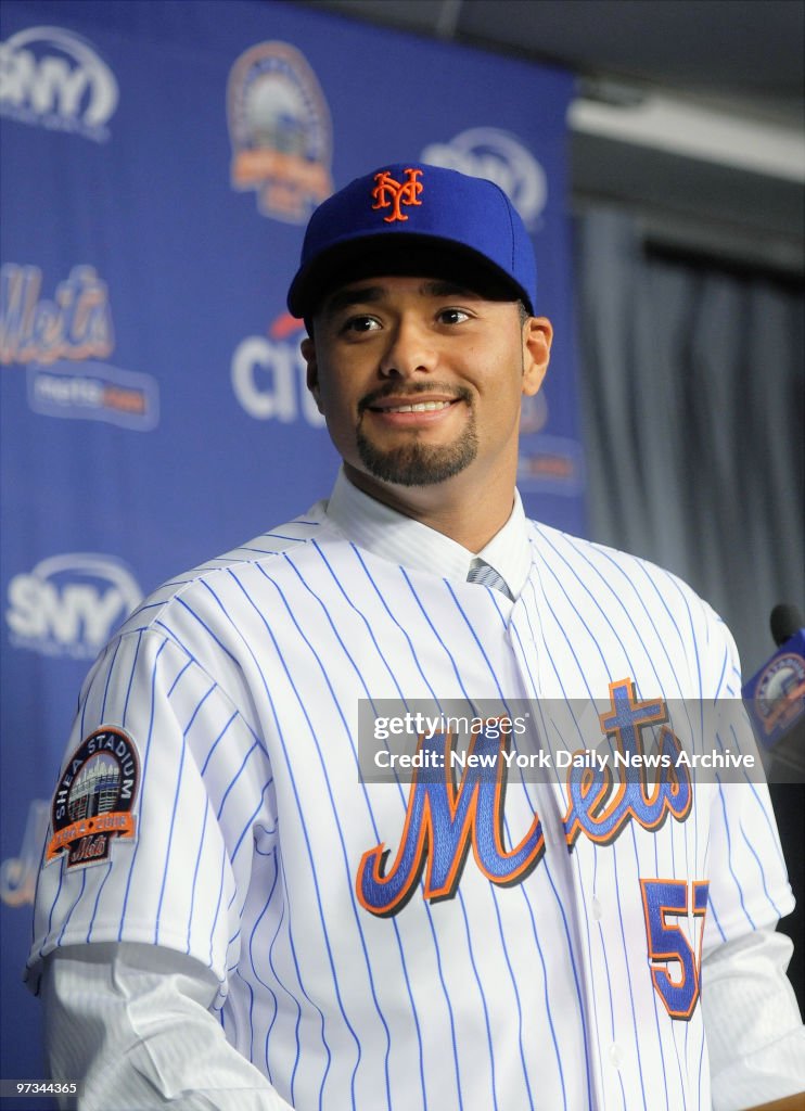 Pitcher Johan Santana wears his new cap and jersey during a