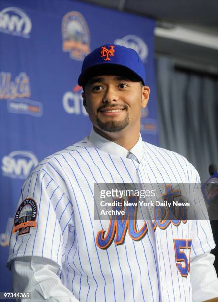 Pitcher Johan Santana wears his new cap and jersey during a news conference at Shea Stadium's Diamond Club, where he was introduced at the newest...