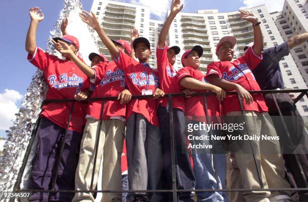 Players of the Rolando Paulino All-Stars wave to their fans during a parade honoring them on the Grand Concourse in the Bronx. Crowds turned out to...