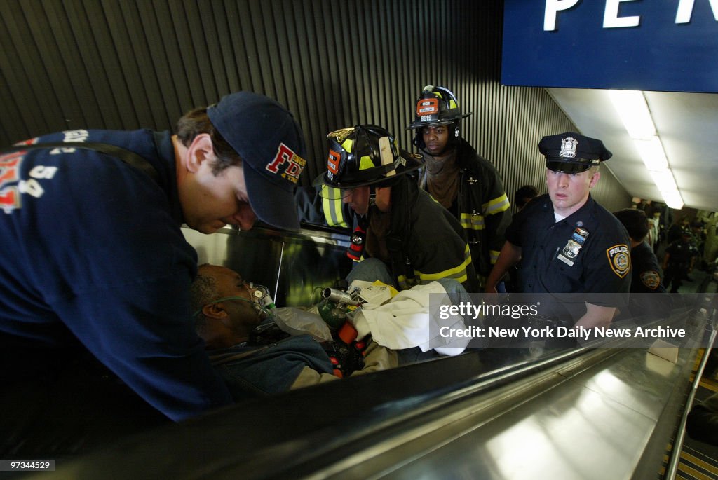 Police and Fire Department rescue workers carry a man from P