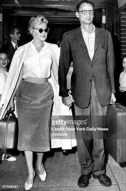 Playwright Arthur Miller and Marilyn Monroe at airport.