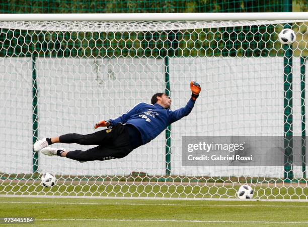 Nahuel Guzman of Argentina dives for a save during an open to public training session at Bronnitsy Training Camp on June 11, 2018 in Bronnitsy,...