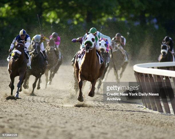 Point Given and jockey Gary Stevens make their move as they round the last turn and head into final stretch at the 133rd running of the Belmont...