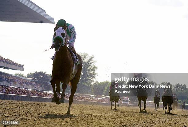 Point Given and jockey Gary Stevens ride to victory, winning the 133rd running of the Belmont Stakes at Belmont Park with a commanding 12??-length...