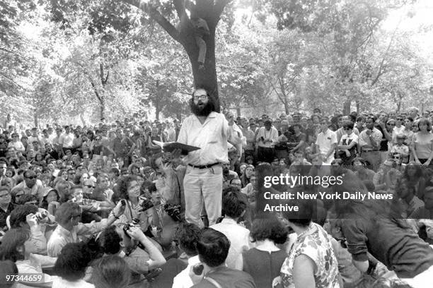 Poet Allen Ginsberg reading his work to a crowd in Washington Square Park.