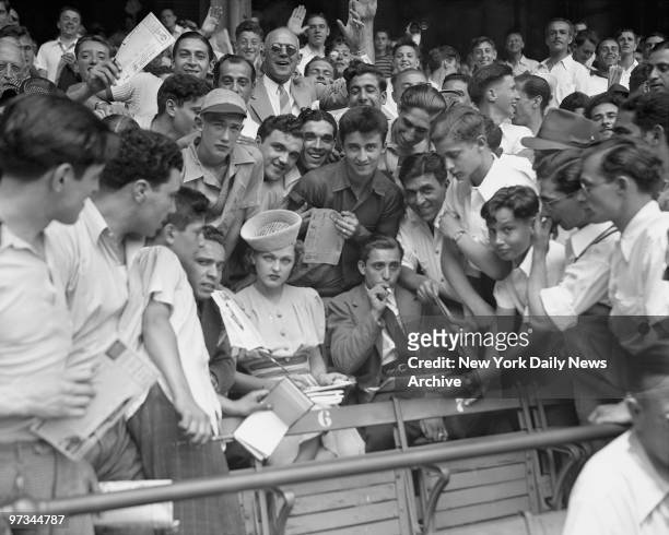 Practically mobbed Dorothy Arnold signs autographs at Yankee Stadium. Where the New York Yankees were playing the Washinton Senators.