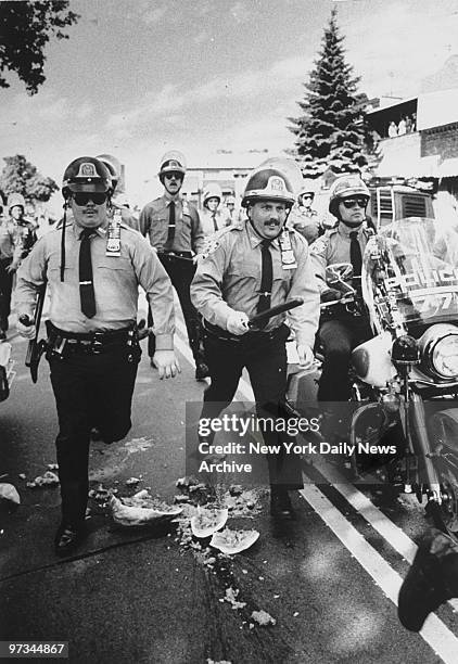 Police chase demonstrator who smashed a watermelon in the street in defiance of a demonstration for Yusuf Hawkins on 20th Ave. In Bensonhurst.