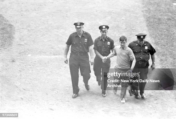 Police chase partisans who leaped from stands at Yankee Stadium to unfurl anti-Castro banner. Incident occured in opener of twin-bill watched by...