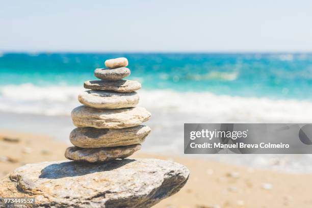 stacked pebbles in katergo beach - stack of sun lounges stock pictures, royalty-free photos & images