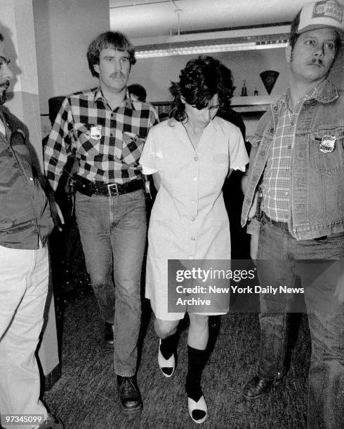 Police escort Kathy Boudin into police headquarters in Nanuet, N.Y., after she was arrested for taking part in a deadly Brink's armored car heist....