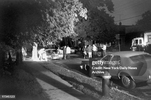 Police examine the car in which Judith Placido was shot to death by a mysterious .44 caliber gunman who was believed to be the Son of Sam killer.