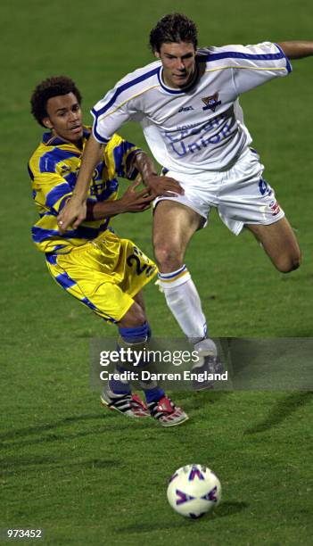 Lawrence Drake of Brisbane tackles Nick Orlick of Parramatta during the round 18 National Soccer League match between the Brisbane Strikers and the...