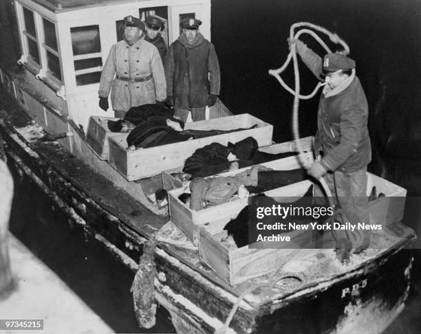 Police launch brings bodies of victims of the ill-fated liner Mohawk from the Coast Guard boat to the foot of E. 29th St. They were then removed to...