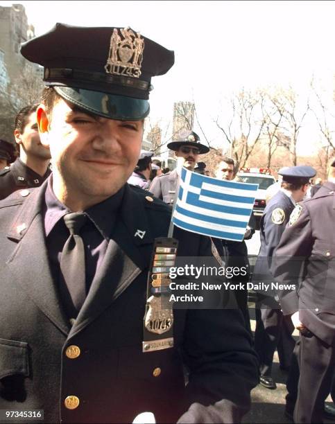 Police Officer George Tsoukaris of the 71st Precinct in Brooklyn, has his Greek flag flying above his commendations during Greek Independence Day...