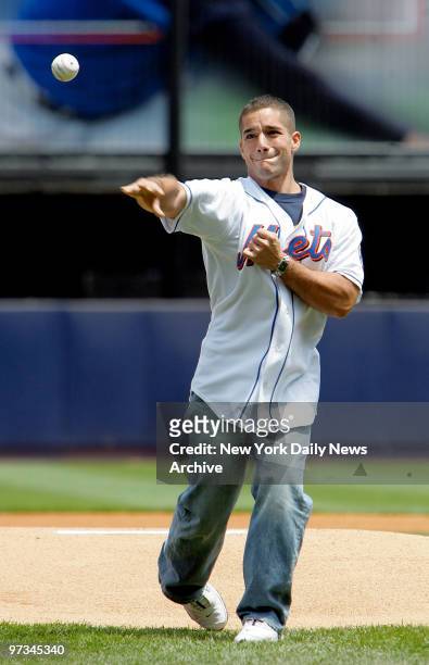 Police Officer Vincent Schiavarelli throws out the ceremonial first pitch at the start of a game between the New York Mets and the Florida Marlins at...