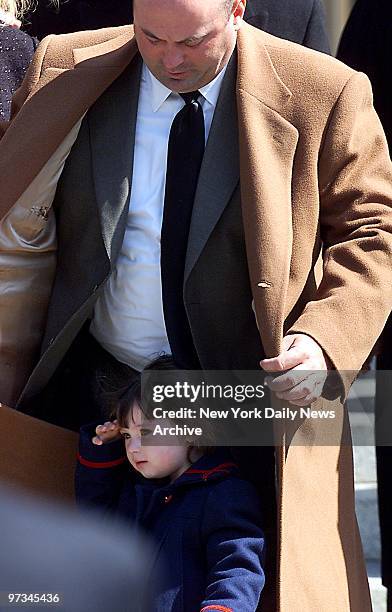 Police Officer James Smith looks down at his daughter, Patricia who salutes as casket is brought out of Our Lady of Lourdes Roman Catholic Church in...