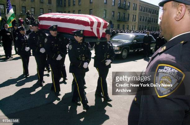 Police officers carry the flag-draped coffin of Detective Jamie Betancourt into the Church of St. Raymond in Parkchester, Bronx. Betancourt a...