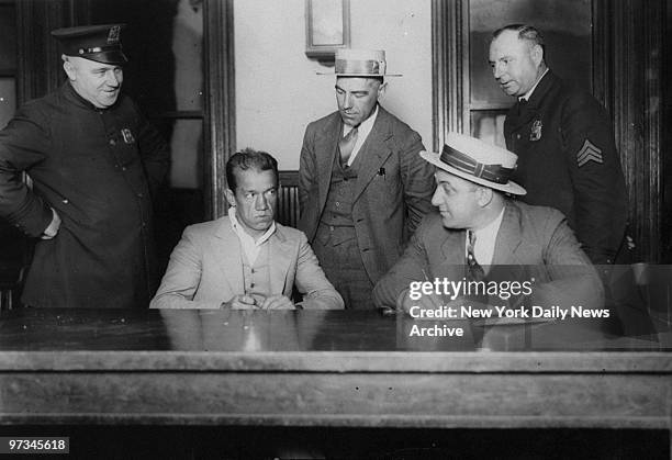 Police Officers Pat McCambridge, John Smith, Charles Marz and Sgt. Frank Giordano question prisoner Juan Martychuk.