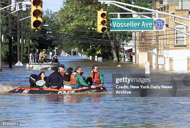 Police use boats and rafts to evacuate people due to flooded streets in the aftermath of Hurricane Floyd in Bound Brook, NJ.