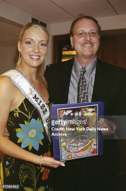 Pop artist Charles Fazzino shows Miss USA Kandace Krueger his official USA Tennis Foundation artwork at a party marking 18 years of the U.S. Open on...