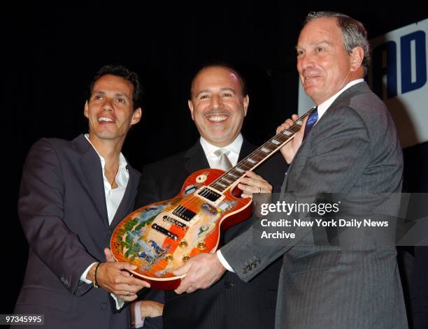 Pop star Marc Anthony and Tommy Matola, head of Sony Music, present an original Les Paul guitar to Mayor Michael Bloomberg at The Theater at Madison...