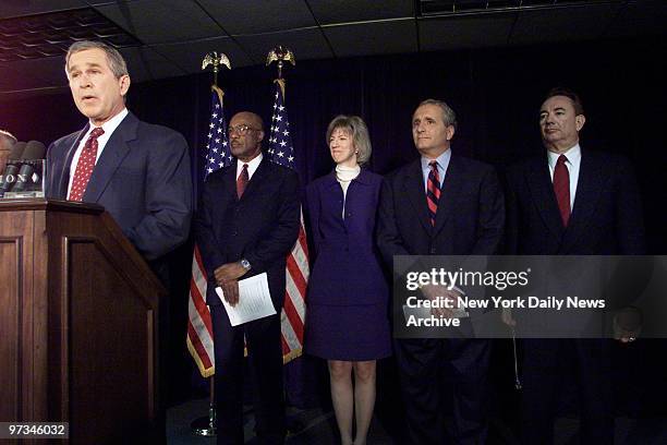 President-elect George W. Bush announces four more appointments for his new administration at Washington news conference. Looking on are Rodney...