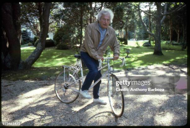 Portrait of American author Joseph Heller on a bicycle, Long Island, NY, 1998.