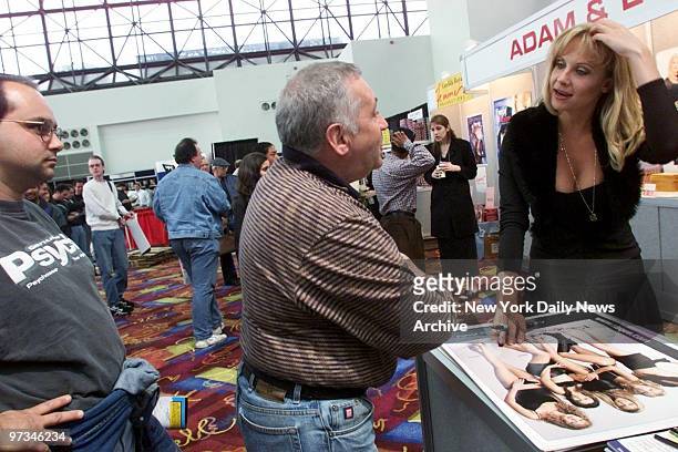 Porn star Julie Ashton signs posters of herself for fans at the Erotica Show at the Jacob Javits Convention Center.