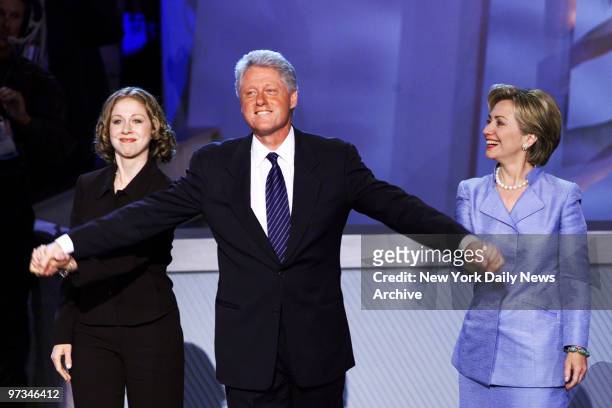 President Bill Clinton accepts applause with daughter Chelsea and wife Hillary after delivering his speech at the Democratic National Convention at...
