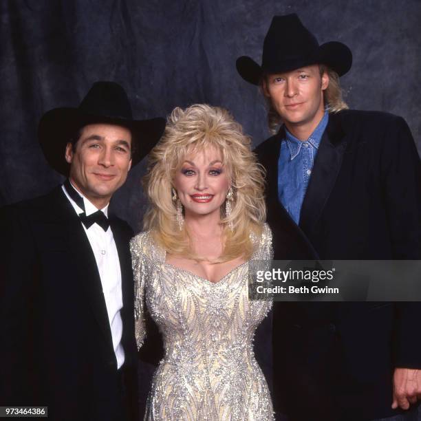 Country singer and songwriter Clint Black, Dolly Parton, and Alan Jackson backstage before the CMA Award Show Backstage October 10, 1988 in...