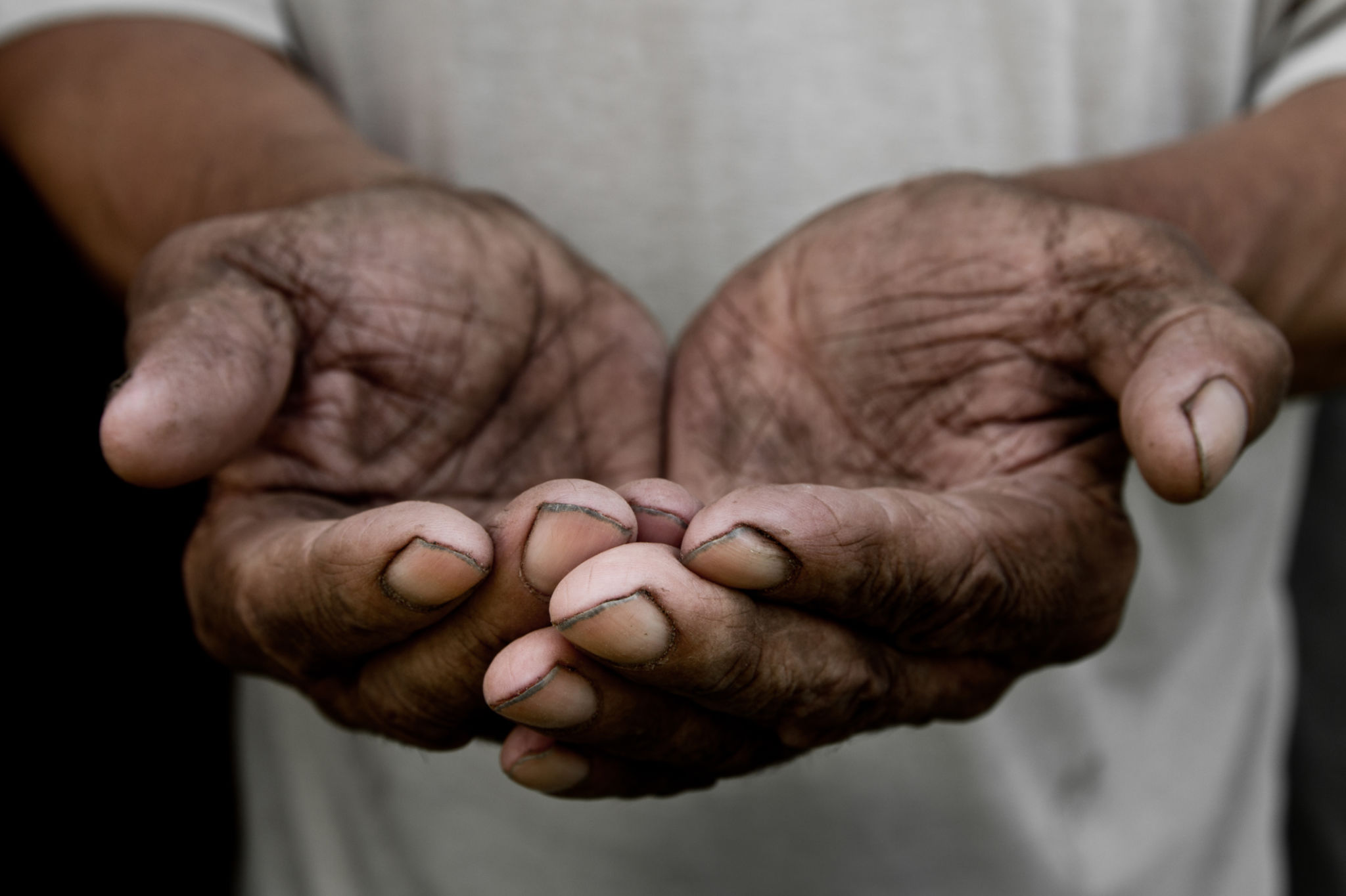 The poor old man's hands beg you for help. The concept of hunger or poverty. Selective focus. Poverty in retirement. Alms The poor old man's hands beg you for help. The concept of hunger or poverty. Selective focus. Poverty in retirement. Alms