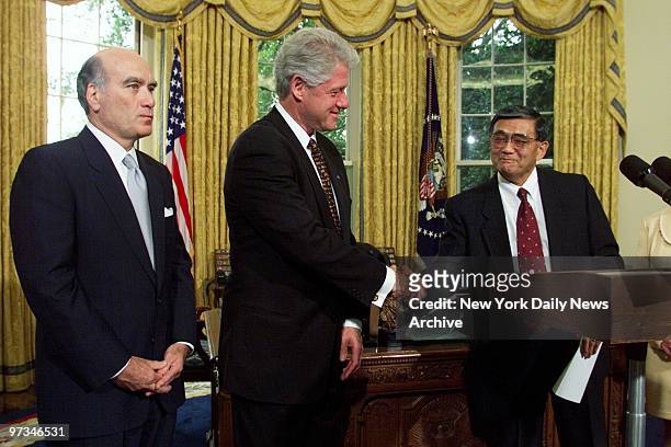 President Bill Clinton congratulates Norm Mineta after nominating him to be secretary of commerce. Outgoing Commerce Secretary William Daley looks on...