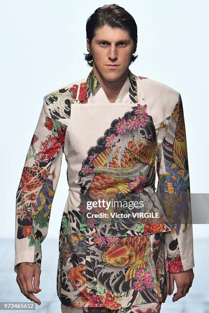 Model walks the runway at the Alex Mullins Spring/Summer 2019 fashion show during London Fashion Week Men's June 2018 on June 10, 2018 in London,...