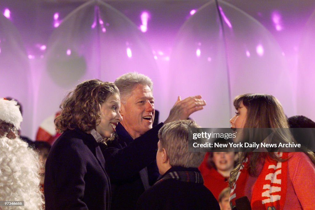 President Bill Clinton takes the lead singing Christmas caro