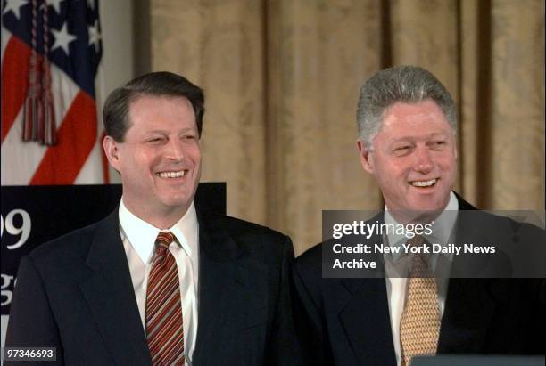 President Bill Clinton unveils his $1.7 trillion balanced budget for fiscal year 1999 in the East Room of the White House. With him is Vice President...
