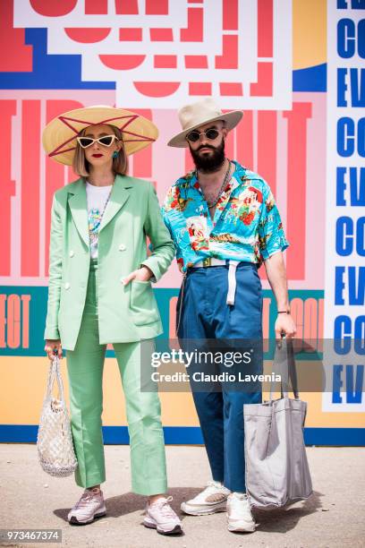 Guests, wearing a green suit and a colorful shirt with blue trousers , are seen during the 94th Pitti Immagine Uomo at Fortezza Da Basso on June 13,...