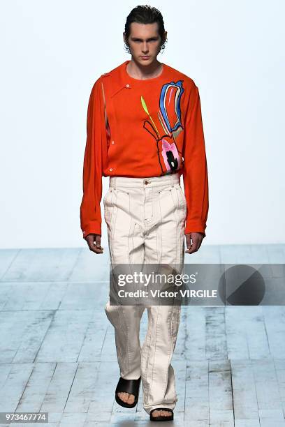 Model walks the runway at the Alex Mullins Spring/Summer 2019 fashion show during London Fashion Week Men's June 2018 on June 10, 2018 in London,...