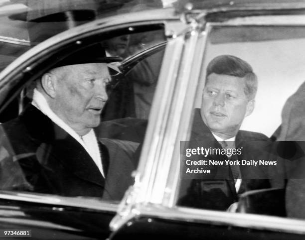 President Dwight Eisenhower and President-elect John F. Kennedy ride together to Kennedy's inauguration at the Capitol Building in Washington, D.C.