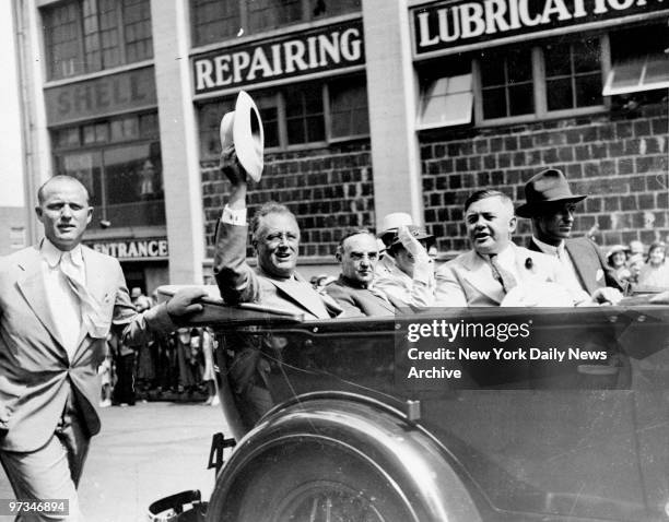 President Franklin Roosevelt rides with Governor Julius Meier to inspect Bonneville Power Dam. Also riding with the President are Mrs. Eleanor...