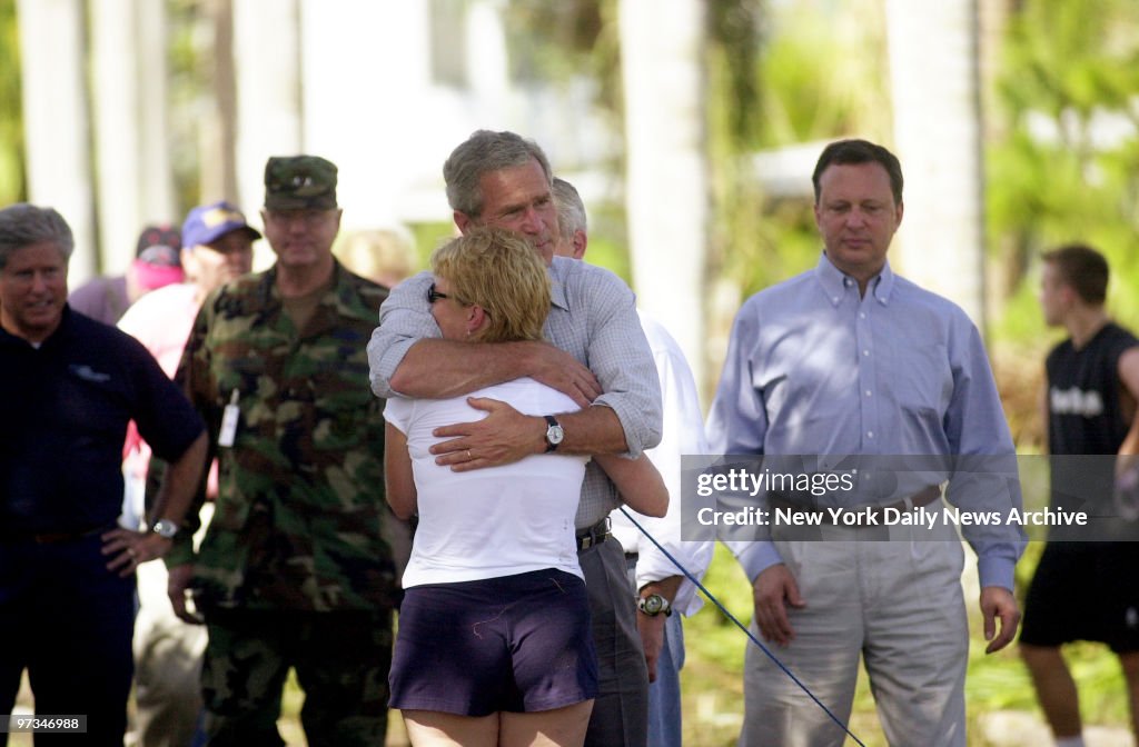 President George W. Bush hugs Tricia Nichols, a nurse, at Pu