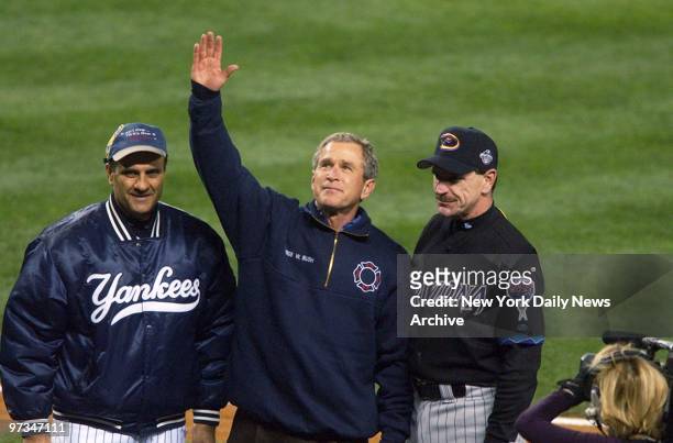 President George W. Bush, standing with New York Yankees' manager Joe Torre and Arizona Diamondbacks' manager Bob Brenly , acknowledges applause from...