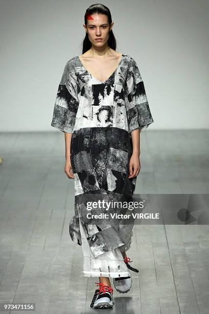 Model walks the runway at the Christopher Raeburn Spring/Summer 2019 fashion show during London Fashion Week Men's June 2018 on June 10, 2018 in...