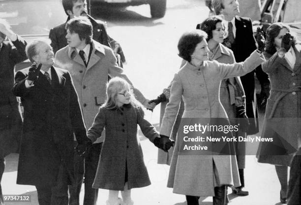 President Jimmy Carter and Rosalynn walk with daughter Amy, in inaugural parade.