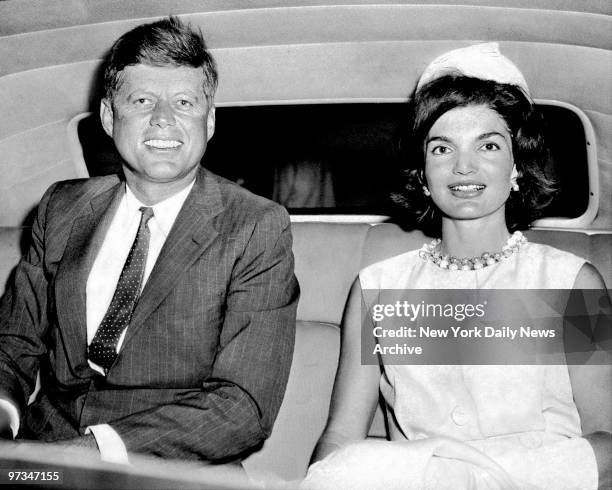 President John F. Kennedy with wife Jacqueline in car at Idlewild Airport.