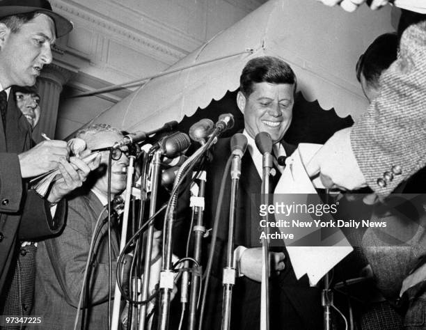 President-elect John F. Kennedy talks to reporters after leaving White House conference.