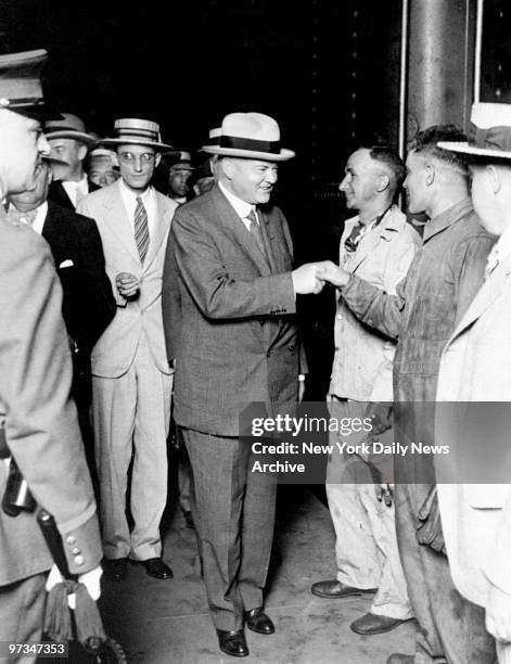 Presidential candidate Herbert Hoover shakes hands with engine crew during a stop in Chicago.