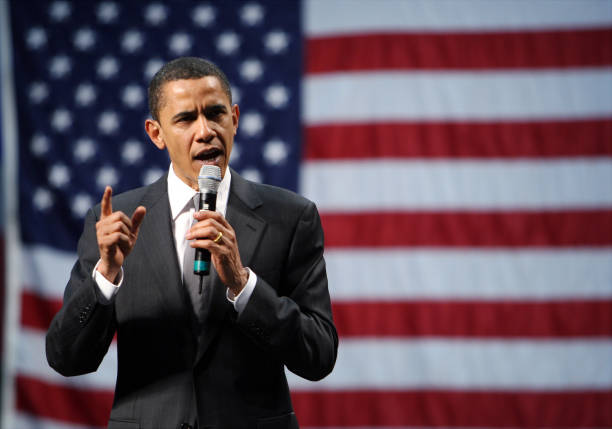 Presidential candidate Sen. Barack Obama stands against the backdrop of an American flag as he speaks during a campaign rally at the University of...